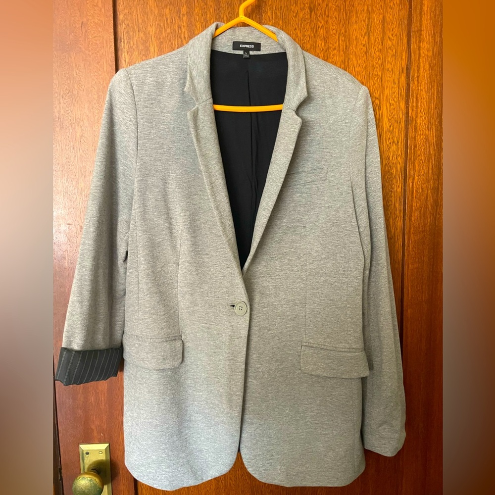 Versatile gray blazer lined with pinstripe. Never worn.